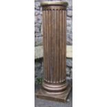 A gilt painted pedestal in the classical style of cylindrical form with fluted detail and square