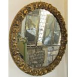 A gilt framed circular wall mirror with repeating rose surround, 55 cm in diamter