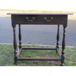 An 18th century oak side table, with single frieze drawer, raised on four turned supports, united by