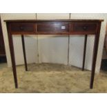 A Georgian mahogany side table fitted with one real and two dummy frieze drawers raised on slender