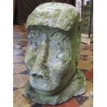 A reclaimed and well weathered Easter Island head 40 cm high