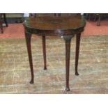 An Edwardian mahogany occasional table of oval form raised on square tapering supports with original