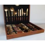 A canteen of bronze wooden handled cutlery made in Thailand (eight settings but one or two pieces