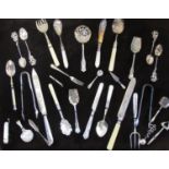 A framed and glazed collection of Victorian silver plate cutlery