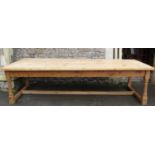 A large Victorian style scrubbed pine farmhouse kitchen table, with plank top, raised on turned