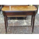 A Georgian mahogany D end fold-over top tea table with reeded borders, raised on four turned and