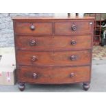 A Victorian mahogany bow fronted bedroom chest of two short over three long graduated drawers with