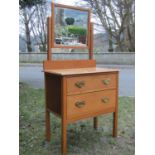 Early 20th century stripped oak dressing chest, the raised rectangular swing mirror with bevelled