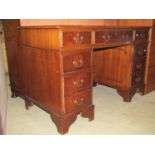 A reproduction Georgian style mahogany veneered kneehole twin pedestal writing desk with inset