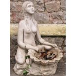 A reclaimed garden water feature/fountain in the form of a kneeling nude female long haired