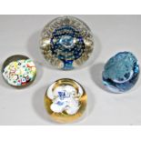 Four various glass paperweights to include a large dump paperweight with bubbled and swirled