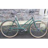 A vintage ladies bicycle (probably a Raleigh) with over painted tubular steel frame and Brooks