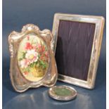 Three silver frames to include a larger rectangular easel frame with rope twist borders, a frame
