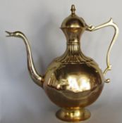 A large bulbous brass Arabic style coffee pot with duck beak spout, 42 cm wide