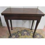 A George III mahogany foldover top tea table of rectangular form raised on four pad feet, 76cm max