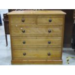 A late Victorian satin birch bedroom chest of two short over three long graduated drawers with