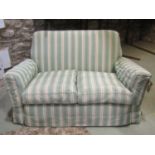 A two seat sofa with shaped outline, upholstered finish with alternating striped upholstery and