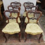 A set of six Victorian rosewood dining chairs with serpentine seats and cabriole forelegs, the