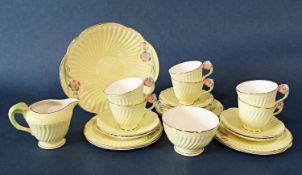A collection of Crown Devon yellow ground teawares with floral moulded handles comprising sugar