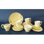 A collection of Crown Devon yellow ground teawares with floral moulded handles comprising sugar