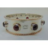 Impressive Guild of Handicrafts silver bangle set with cabochon garnets and with gold rope twist