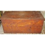 An antique pine/possibly cedar chest with iron work drop side carrying handles and hinged lid