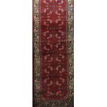 Persian Hamadan full pile runner with geometric decoration of blue flowers upon a red ground, 720