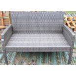 A contemporary faux wicker two seat garden or conservatory sofa, with shaped outline, 114cm long