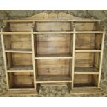 A stripped pine wall mounted bookcase, with segmented adjustable shelves, 130cm wide x 27cm deep x