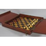 A Whittington travelling mahogany cased chess set, with red and white bone pieces (complete)