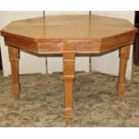 A Victorian stripped and waxed pine kitchen table of octagonal form to seat four, raised on square