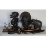 Tribal Art: a wooden carved leather clad mask, a carved figure, an ebony elephant and a five