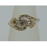 Early 20th century diamond crossover style ring in white metal, centre stone 0.25cts approx, size J,