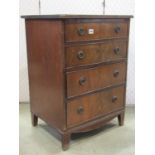 An antique Georgian style mahogany chest of two long drawers beneath a cupboard with mock drawer