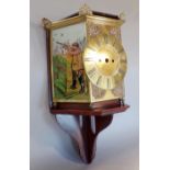 Unusual clock case with brass dial, flanked by coloured glass panels showing sportsmen, with