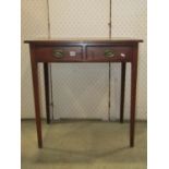 A small simple Georgian oak side table fitted with two frieze drawers raised on slender square