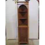 A small reproduction Georgian style yewwood veneered freestanding corner cupboard enclosed by a