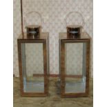 A pair of contemporary copperised lanterns of square cut form with glazed panels, single door and