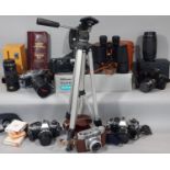A collection of vintage cameras and equipment including Olympus OM10 and OM30 models, cased Adox,