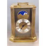 Unusual brass cased Hermle quartz moon phase mantel clock, 21cm high