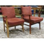 A matched pair of mid 20th century open armchairs in the Parker Knoll style, one in stained beech,