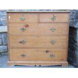 A Victorian stripped pine bedroom chest of two short over three long drawers set on a moulded