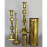 Brassware: a pair of turned brass candlesticks, shell casing, three coaching horns by Alfred May,