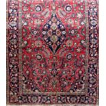 Antique Persian village rug in the Kashan manner with central blue floral medallion surrounded by
