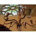 An Art Deco brass eight branch chandelier with simple cut glass drops, 120cm high approx (plus