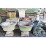 A pair of reclaimed shallow circular garden urns, with rope twist rims and repeating vine detail,
