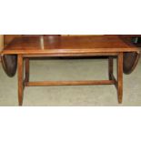 A walnut occasional table of rectangular form with two drop leaves, raised on square cut supports