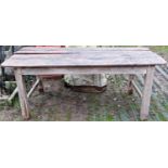 An old weathered, scrubbed pine farmhouse kitchen table of rectangular form with tongue and groove