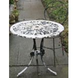 A cast aluminium garden terrace table with circular pierced top raised on swept supports, with