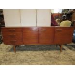 Avalon teak sideboard enclosed by three doors and three drawers with moulded handles and supports,